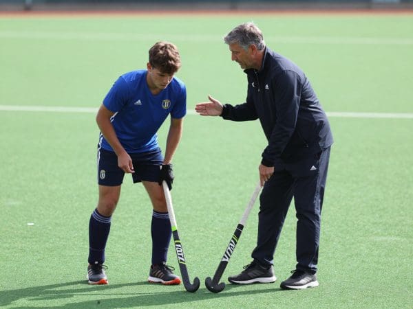 Hockey player with coach